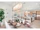Elegant dining area featuring a set table and open view to the stylish and comfortable living area at 32249 Tribeca Ave, Wesley Chapel, FL 33543