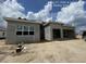 The exterior features a modern design with large windows, stucco facade and an attached two car garage at 32249 Tribeca Ave, Wesley Chapel, FL 33543