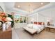 Inviting main bedroom with a four-poster bed, stylish decor, and a window with natural light at 32249 Tribeca Ave, Wesley Chapel, FL 33543
