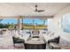 Inviting covered patio boasts comfortable seating with views of the pool and landscaped backyard at 32249 Tribeca Ave, Wesley Chapel, FL 33543
