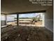 Unfinished patio showcases view of construction for a future pool and landscaping, highlighting outdoor living potential at 32249 Tribeca Ave, Wesley Chapel, FL 33543