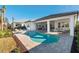 Stunning backyard features a private pool, spa, covered patio and luxurious outdoor living space at 32249 Tribeca Ave, Wesley Chapel, FL 33543