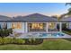 Beautiful outdoor oasis featuring a refreshing private pool, spa, covered patio and manicured landscaping at 32249 Tribeca Ave, Wesley Chapel, FL 33543