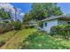 Lush green backyard with a healthy lawn and some landscaping, perfect for outdoor enjoyment at 3416 W Morrison Ave, Tampa, FL 33629