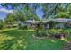 Green backyard featuring lush landscaping, a well-maintained lawn, and mature trees, creating a serene outdoor oasis at 3416 W Morrison Ave, Tampa, FL 33629