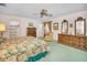 Bright bedroom with floral bedding, ceiling fan, and dual dressers for ample storage at 3416 W Morrison Ave, Tampa, FL 33629