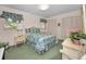 Inviting bedroom featuring floral bedding, matching nightstands, and spacious closets at 3416 W Morrison Ave, Tampa, FL 33629