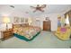 Spacious bedroom featuring floral bedding, a ceiling fan, and plenty of natural light at 3416 W Morrison Ave, Tampa, FL 33629