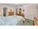 Bedroom with a cozy bed, wooden dressers, and a closet with sliding doors at 3416 W Morrison Ave, Tampa, FL 33629