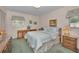 Bedroom showcasing a comfortable bed, vintage furniture, and bright natural light at 3416 W Morrison Ave, Tampa, FL 33629