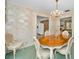 Traditional dining room featuring a round wood table, chairs, chandelier, and floral wallpaper at 3416 W Morrison Ave, Tampa, FL 33629