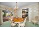 Traditional dining room with wood table, chairs, chandelier and sliding glass doors to the outdoor space at 3416 W Morrison Ave, Tampa, FL 33629