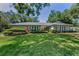 Well-maintained one-story home featuring a lush green lawn and lovely landscaping at 3416 W Morrison Ave, Tampa, FL 33629