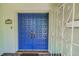 Beautiful blue double front doors, adorned with decorative hardware and a secure gated entrance at 3416 W Morrison Ave, Tampa, FL 33629