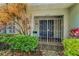 Close-up of a home's charming gated front entrance with a blue double door at 3416 W Morrison Ave, Tampa, FL 33629