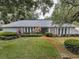 Attractive single-story home featuring a well-manicured lawn and mature trees at 3416 W Morrison Ave, Tampa, FL 33629