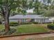 Attractive single-story home featuring a well-manicured lawn and shade trees at 3416 W Morrison Ave, Tampa, FL 33629
