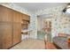 Open kitchen showcasing wooden cabinets, built-in desk, and access to a formal dining area at 3416 W Morrison Ave, Tampa, FL 33629