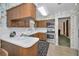 Traditional-style kitchen featuring wood cabinets, white countertops, and a view to the dining room at 3416 W Morrison Ave, Tampa, FL 33629