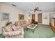 Comfortable living room featuring built-in shelving, a ceiling fan, and natural light at 3416 W Morrison Ave, Tampa, FL 33629