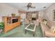 Cozy living room with a brick fireplace, ceiling fan, and sliding glass door to outdoor space at 3416 W Morrison Ave, Tampa, FL 33629