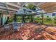 Brick patio with wrought iron table and chairs, and a trellis overhead at 3416 W Morrison Ave, Tampa, FL 33629