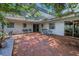 Secluded brick patio featuring a pergola with an outdoor dining set and plenty of sunshine at 3416 W Morrison Ave, Tampa, FL 33629