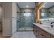 Modern bathroom with double vanity, a large walk-in shower featuring designer tile and fixtures at 344 Bay St, Palm Harbor, FL 34683