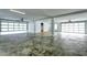 Spacious three-car garage with high ceilings, white walls, and three roll-up doors at 344 Bay St, Palm Harbor, FL 34683