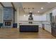 Spacious kitchen boasting an island, stone fireplace, modern appliances and sleek countertops at 344 Bay St, Palm Harbor, FL 34683