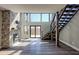 Open-concept living space with fireplace, modern staircase, and large windows for natural light at 344 Bay St, Palm Harbor, FL 34683