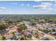 This aerial view shows the home's setting within a neighborhood, close to treed areas and roads at 3535 16Th N St, St Petersburg, FL 33704