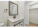 Bathroom featuring a sliding barn door vanity, framed mirror, and neutral color palette at 3535 16Th N St, St Petersburg, FL 33704