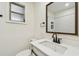 Bathroom features a vanity with a large mirror, a toilet, and a small frosted window at 3535 16Th N St, St Petersburg, FL 33704