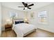 Serene bedroom with a ceiling fan, two windows, and a calming color palette at 3535 16Th N St, St Petersburg, FL 33704