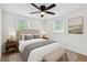 Comfortable bedroom with neutral tones, a ceiling fan, and ample natural light from two windows at 3535 16Th N St, St Petersburg, FL 33704