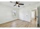 Bright bedroom featuring a ceiling fan, light wood floors, and neutral walls at 3535 16Th N St, St Petersburg, FL 33704