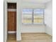 Bedroom features light wood flooring, neutral paint, a window with blinds and a closet at 3535 16Th N St, St Petersburg, FL 33704