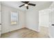 Bedroom with wood-look flooring, window with blinds, and a ceiling fan at 3535 16Th N St, St Petersburg, FL 33704