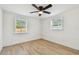 Bedroom featuring light wood flooring, neutral paint, and two windows with blinds at 3535 16Th N St, St Petersburg, FL 33704