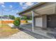 View of backyard from the carport with a concrete driveway at 3535 16Th N St, St Petersburg, FL 33704