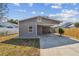 Gray one-story home with a large carport, manicured lawn, and concrete driveway at 3535 16Th N St, St Petersburg, FL 33704
