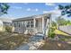 Quaint one-story home boasts fresh exterior paint, a covered porch, and tidy front yard at 3535 16Th N St, St Petersburg, FL 33704