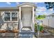 A well-kept exterior with a covered front porch, freshly painted door, and a tidy front yard at 3535 16Th N St, St Petersburg, FL 33704