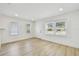 Sunlit living room with new flooring, fresh paint, recessed lighting, and multiple windows at 3535 16Th N St, St Petersburg, FL 33704