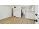 Bright, open living room featuring clean white walls and updated flooring leading into the kitchen area at 3535 16Th N St, St Petersburg, FL 33704