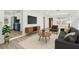 Open-concept living room with modern furnishings, a large TV, and easy access to the kitchen at 3535 16Th N St, St Petersburg, FL 33704