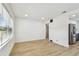 Bright living area showcasing new flooring and easy access to the kitchen with stainless appliances at 3535 16Th N St, St Petersburg, FL 33704