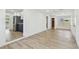 Open living room featuring light wood flooring and neutral paint with a view of the kitchen at 3535 16Th N St, St Petersburg, FL 33704