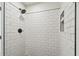 Close up of shower features a rainfall shower head, and white subway tile at 3535 16Th N St, St Petersburg, FL 33704